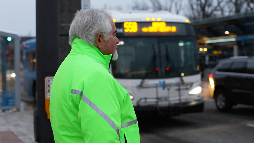 Man wearing high visibility jacket crossing the road