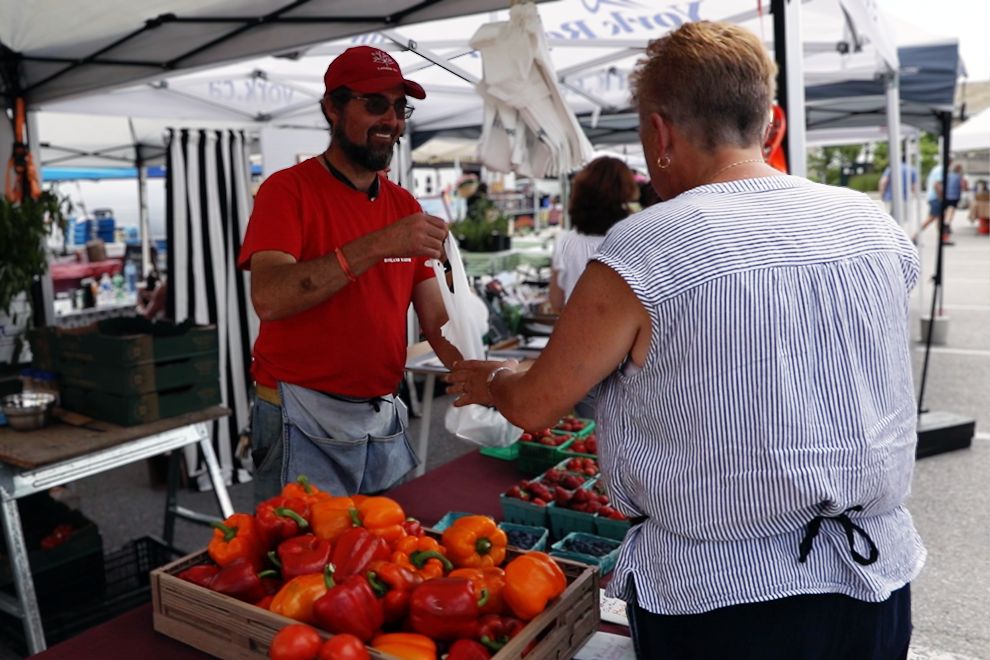 Market vendor interacting with a customer
