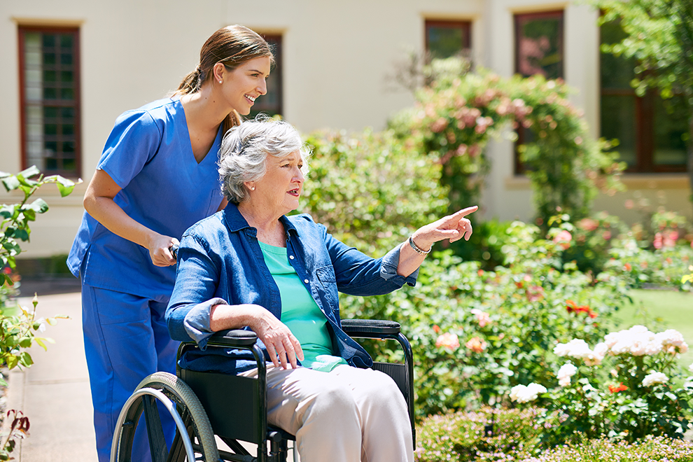 Personal support worker assisting a senior sitting in a wheelchair