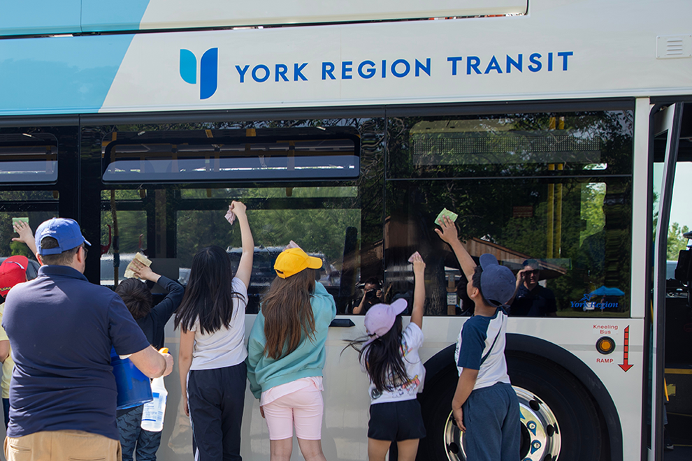 York Region Transit bus parked with people standing outside of it.
