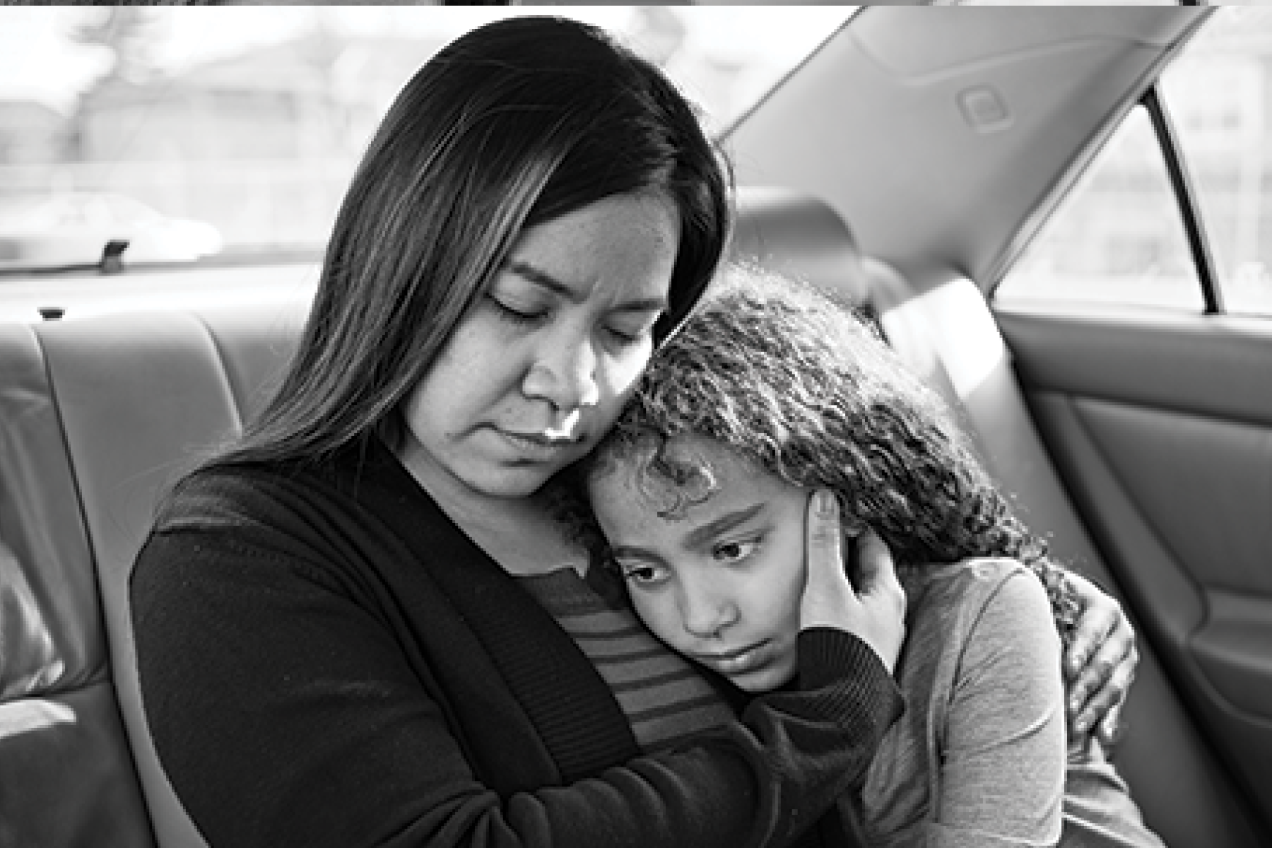 A photo of a woman and child in a car. To you, it's a car. To Olivia and Grace, it's home