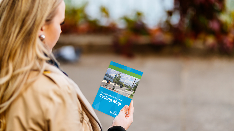 woman looking at Cycling Maps brochure