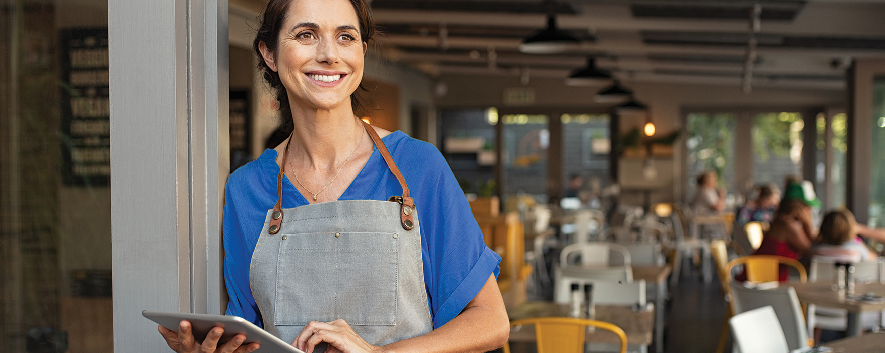 Business woman with a tablet in a restaurant