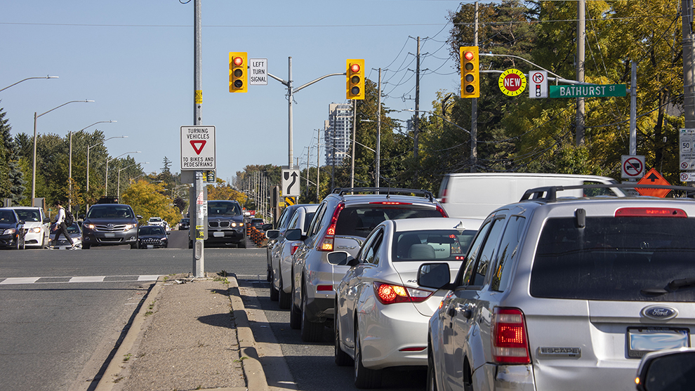 a busy intersection with many cars stopped at the red lights