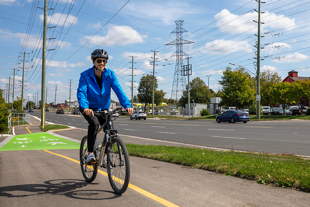 adult riding a bicycle in a cycling lane