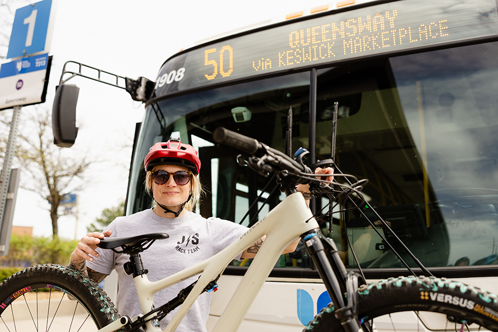 cyclist loading their bicycle on the front of a bus