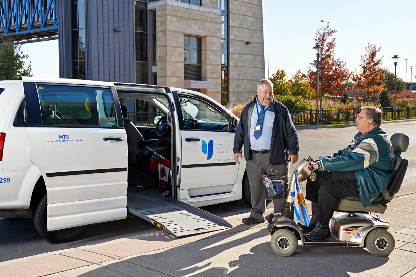 Mobility on Demand vehicle with ramp extended for person in an electric scooter to board