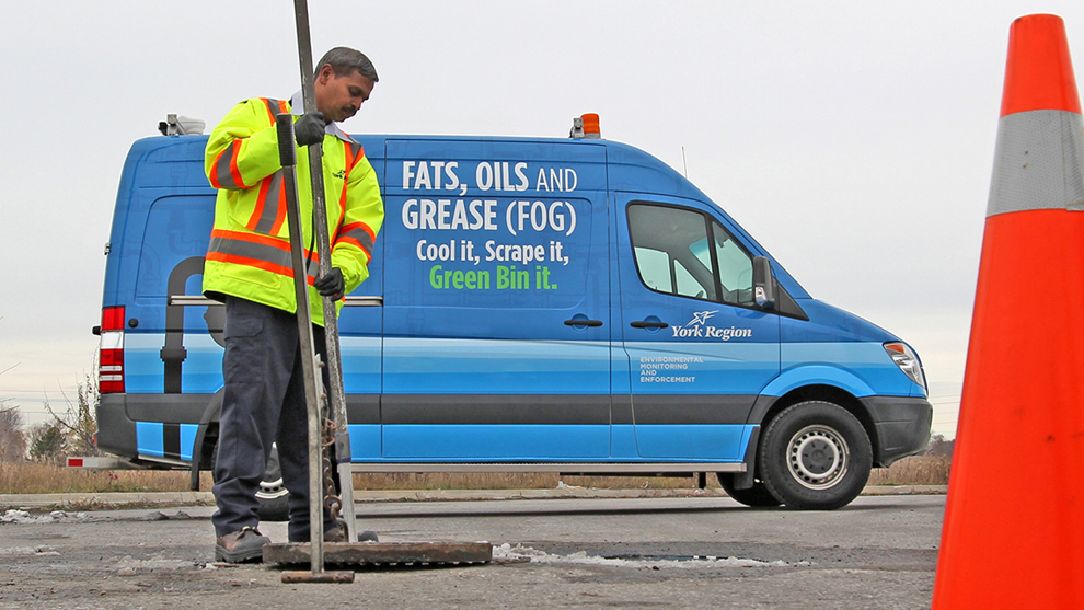 A man checking the sewers with a long pole