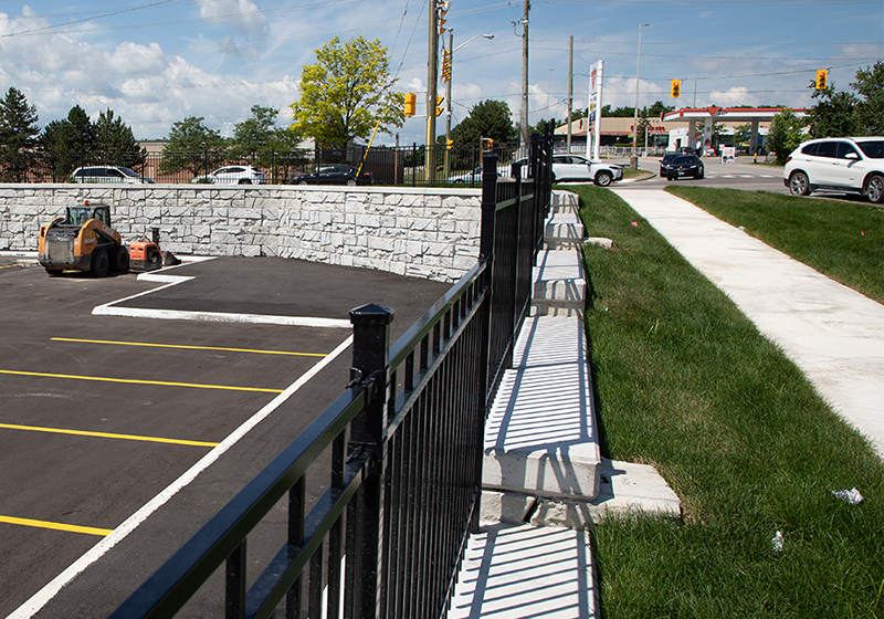 Retaining walls and decorative fencing prevent erosion, provide barriers and create an attractive roadway.