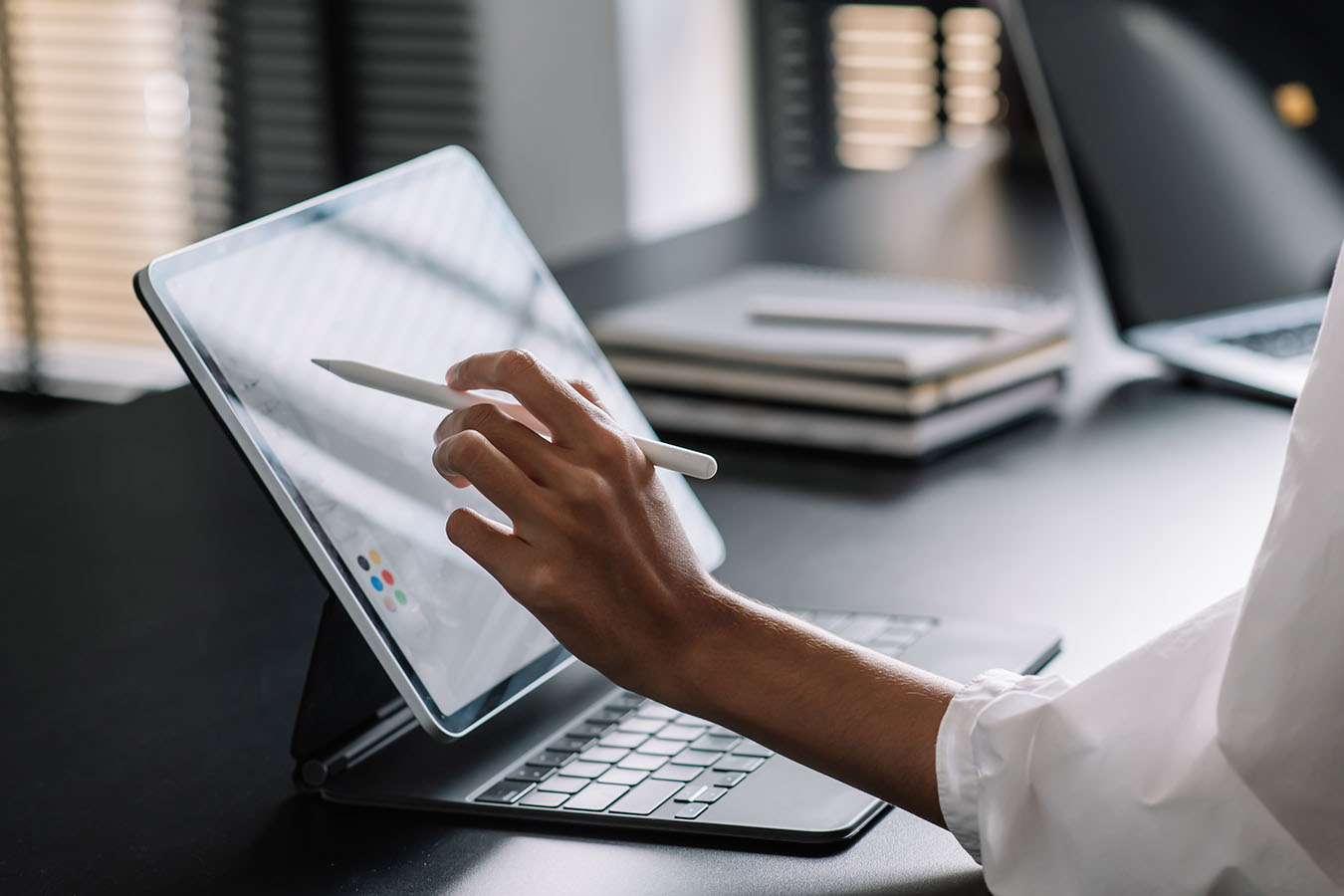 hand with pencil using a touch screen tablet