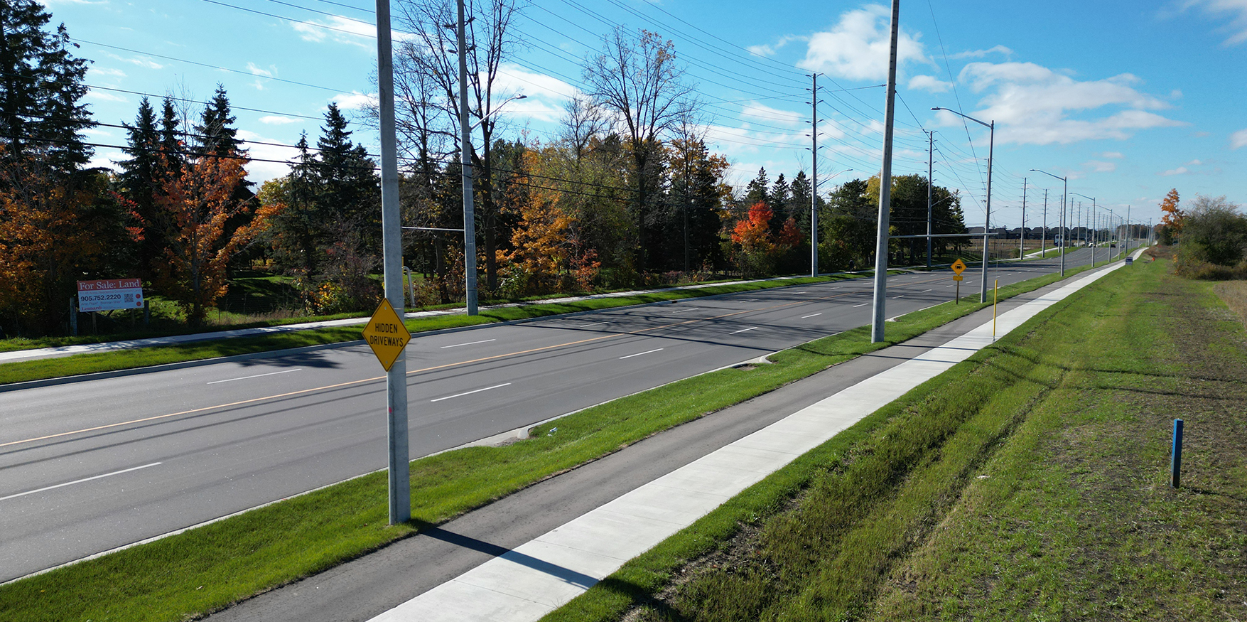 new roadway, sidewalks, cycling paths, grass and trees