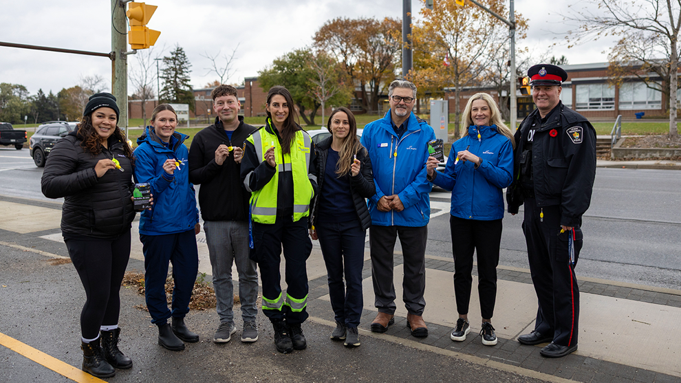 group of staff at an intersection near a school