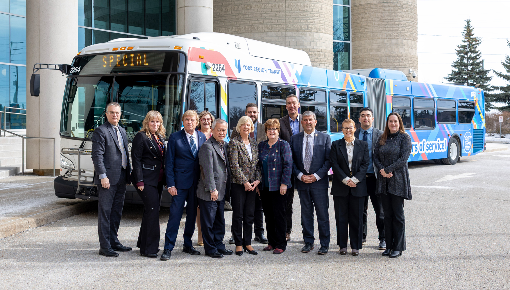 council members standing in front of the YRT 25th anniversary wrapped bus at the York Region Administrative Centre in Newmarket