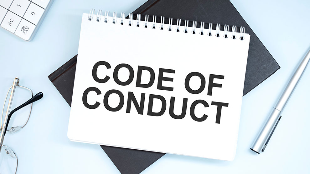 Book with the words code of conduct written on it