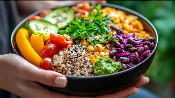 hands holding bowl of vegetables
