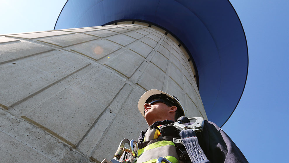 Water operator underneath a water tower