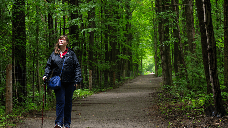 Adult walking on a groomed trail in the forest