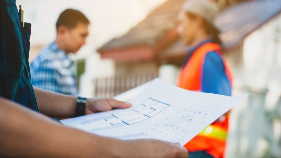 Contractor holding a construction project plan.