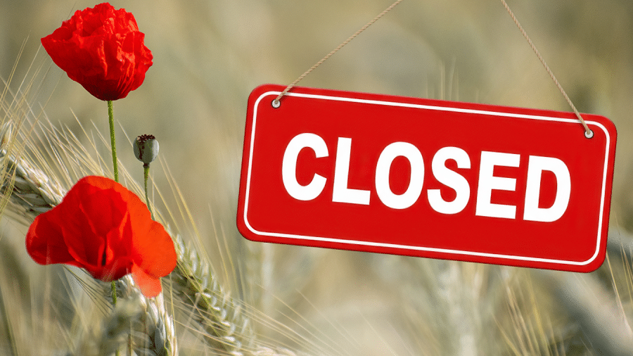 two poppies in a field with the sign that reads closed