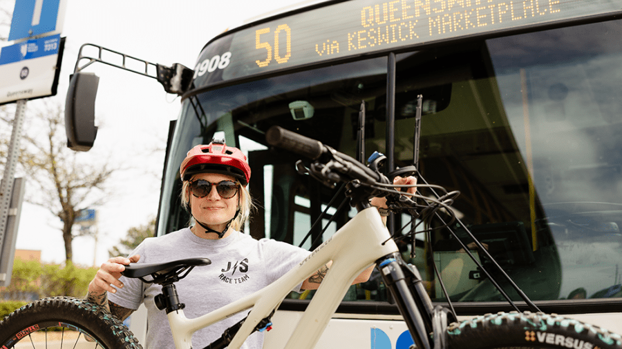 cyclist loading their bicycle on the front of a bus