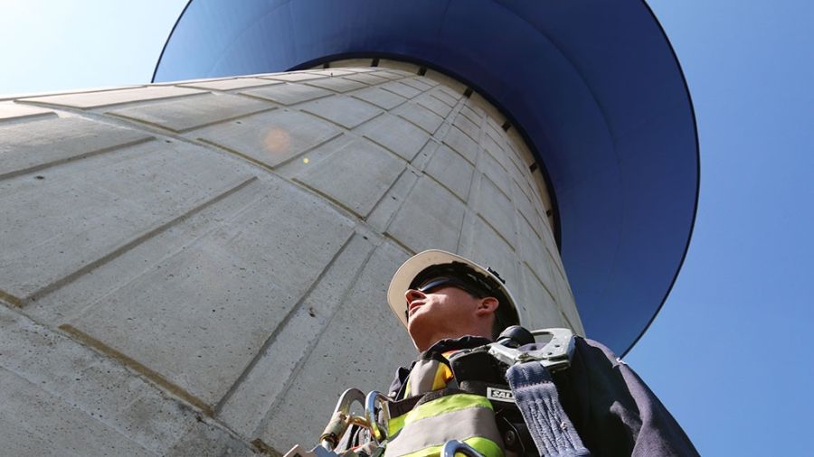 Water operator underneath a water tower