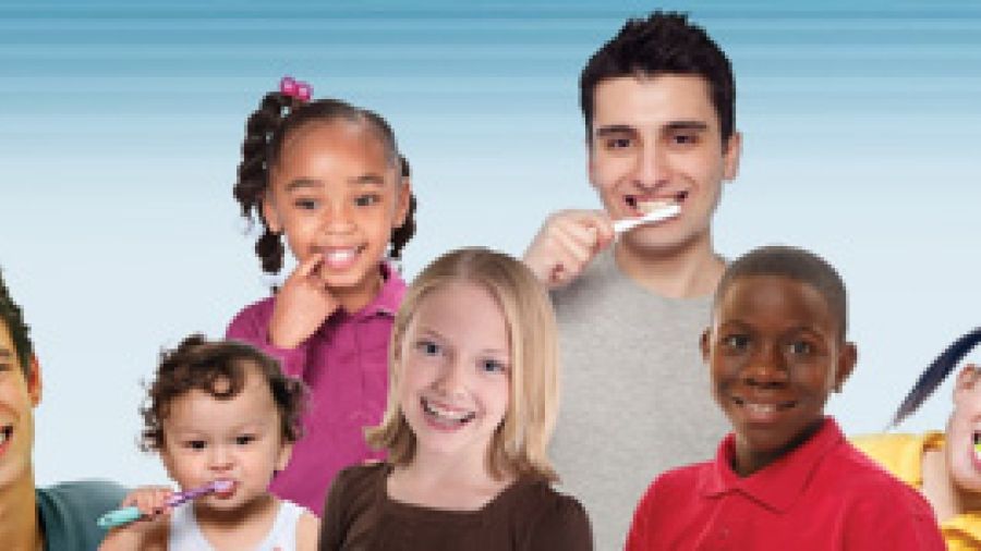 Several children and youths who are smiling or brushing their teeth