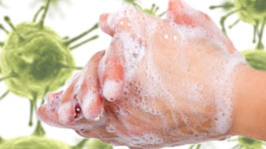 A close up of hands using soap to wash off germs superimposed on a background of viruses.