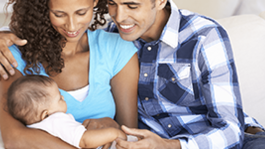 Photo of parents holding an infant