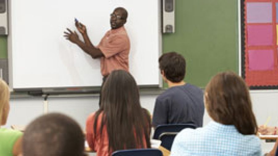 Teacher at the front of class instructing students