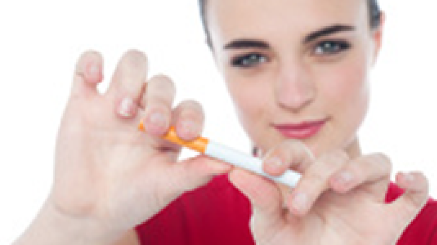 A young woman breaking a cigarette