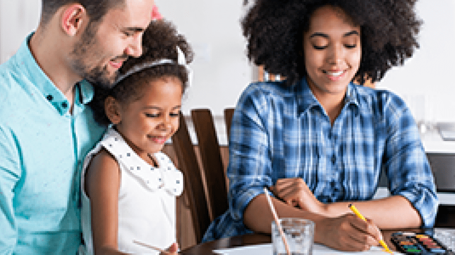 A family doing a craft while sitting at the kitchen table
