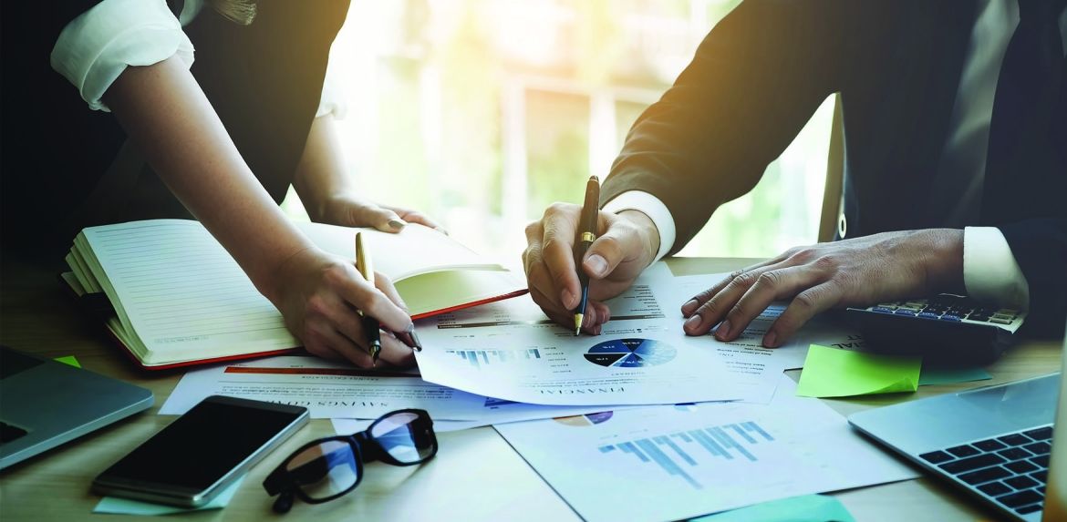 Two people reviewing financial charts