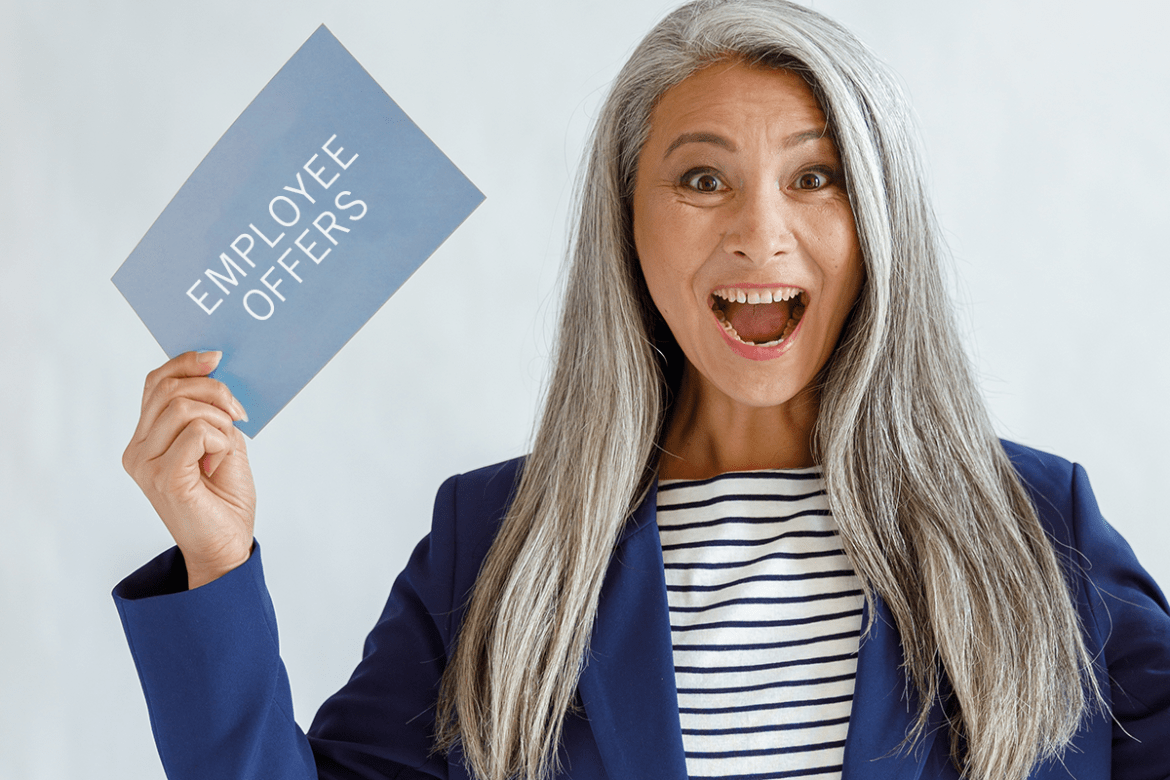 Woman excited holding a card that says employee offers