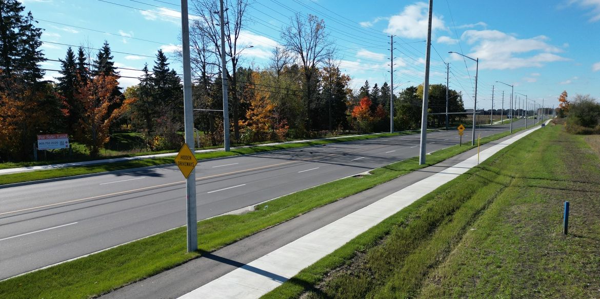 new roadway, sidewalks, cycling paths, grass and trees