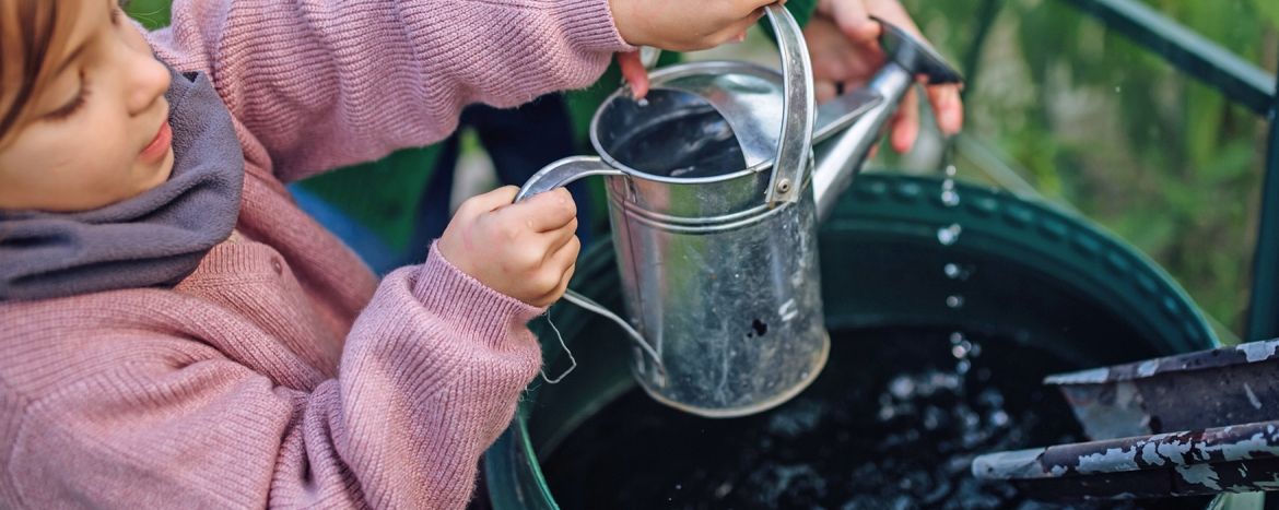 a girl using a watering can