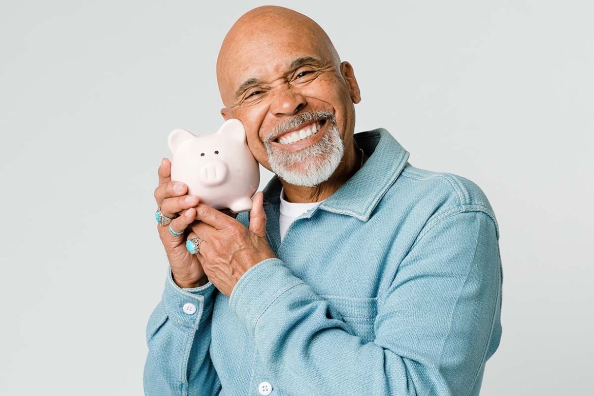 Senior man holding piggy bank