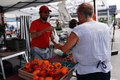 Market vendor interacting with a customer