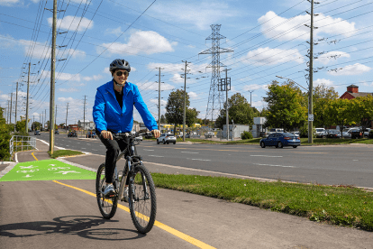 adult riding a bicycle in a cycling lane