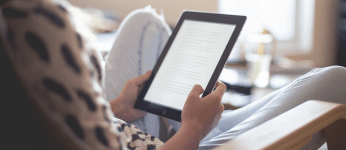 person sitting reading text on a tablet