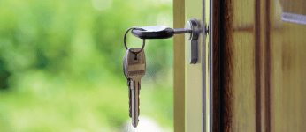 close up of keys in the lock of a front door