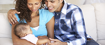 Photo of parents holding an infant