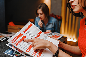 A woman at a restaurant reviewing a menu