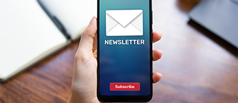 A mobile phone with an email labelled newsletter and a subscribe button